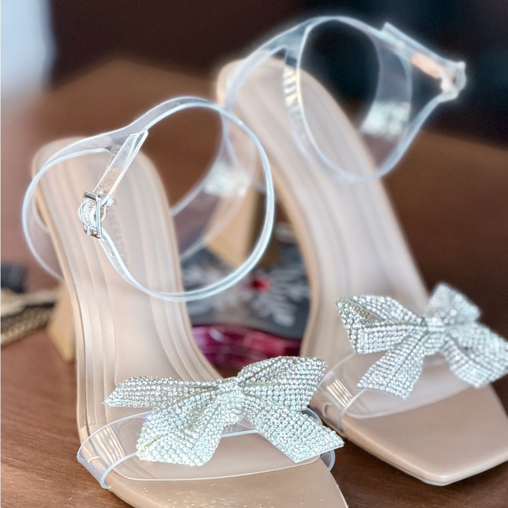 BCBGeneration Women's Sandals with Clear Straps and Silver Bow